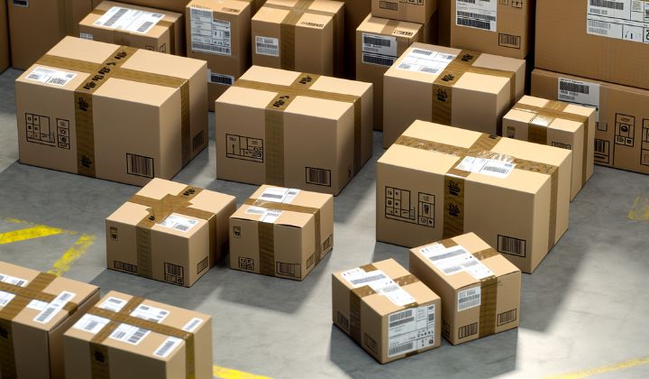 Boxes on the floor in a large Amazon prep center's warehouse.